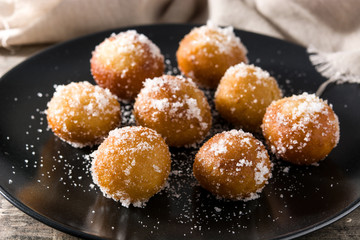 Carnival fritters or buñuelos de viento for holy week on wooden table
