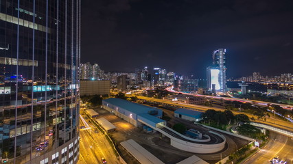 Fototapeta na wymiar Top view of busy traffic night in finance urban timelapse hyperlapse with panorama of city buildings, hong kong city