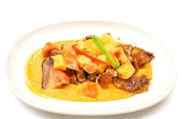 Kaeng Phed Ped Yang (Roasted Duck in Red Curry) , There is a pineapple, tomato and sliced bell pepper on top , Thai food.
