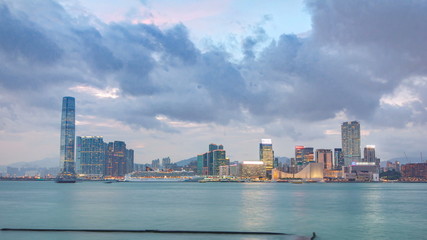Shyline panorama timelapse day to night with International Commerce Centre in West Kowloon, Hong Kong.