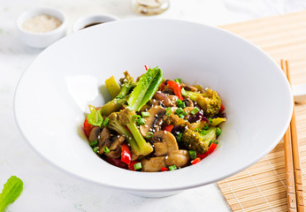 Stir fry vegetables with mushrooms, paprika, red onions and broccoli. Healthy food. Asian cuisine.