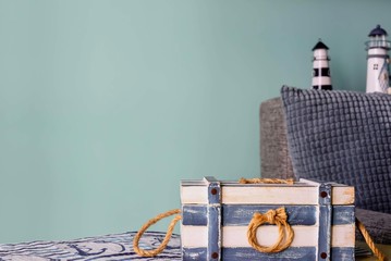 Marine style in the interior of the apartment - a sofa with pillows and the striped casket. Blue...