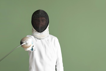 Young male fencer on color background