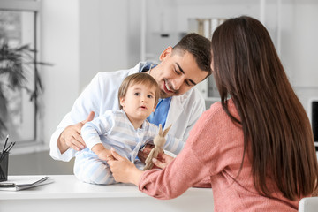 Woman with little baby visiting pediatrician in clinic