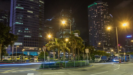 Obraz premium Night view hyperlapse of modern city traffic across street with skyscrapers. Time lapse. Hong Kong