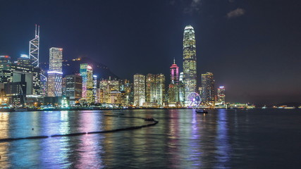 Fototapeta na wymiar Hong Kong, China skyline panorama with skyscrapers at night from across Victoria Harbor timelapse.