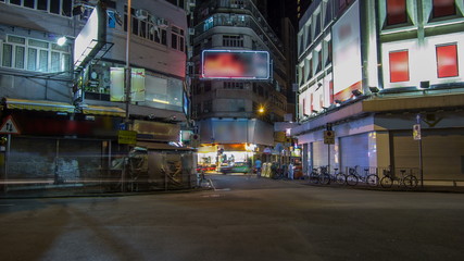 Neon lights on Tsim Sha Tsui street timelapse with traffic.