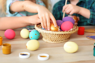 Fototapeta na wymiar Little children painting Easter eggs at home