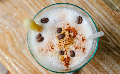 Ice Cappuccino decorated with coffee beans. View from above