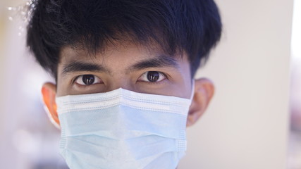 Sick Asian man wearing the surgical mask to protect the germ or virus from the air. 2019-Corona virus from China it's very dangerous.                                 