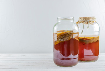 Kombucha superfood pro biotic tea fungus beverage in glass bottle and jar on white background