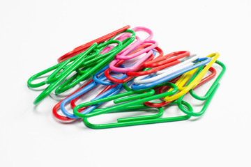 Colorful paper clips isolated on white close-up view.