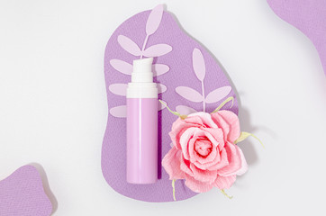 Arrangement of purple make-up bottle with pink rose