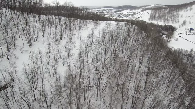 Southern Urals. Bashkir village of Makarovo in the mountains in winter. Aerial view.