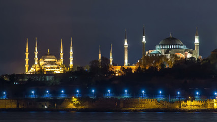 Fototapeta na wymiar Hagia Sophia and Blue Mosque timelapse at night reflected in Bosphorus water. Istanbul, Turkey