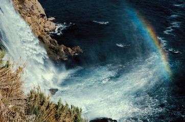waterfall sea rainbow rocks