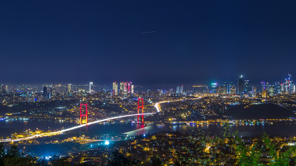Istanbul city skyline cityscape night time lapse view of bosphorus bridge and financial business...