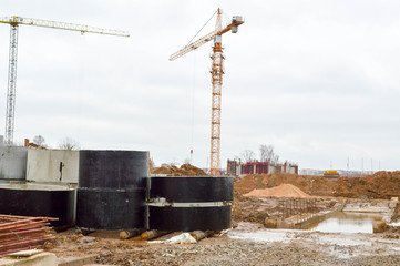 A large modern construction site in the construction of buildings and houses with appliances and...