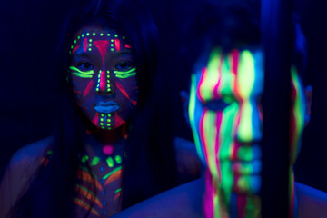 Front view of woman and man with fluorescent make-up