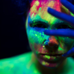 Close-up view of woman with colorful fluorescent make-up