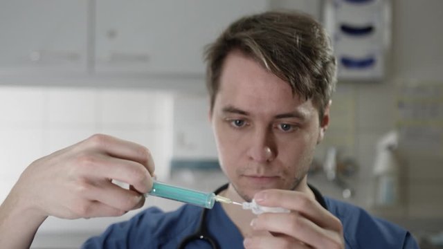 Young Doctor preparing syringe