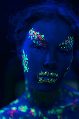 Close-up view of woman with fluorescent make-up