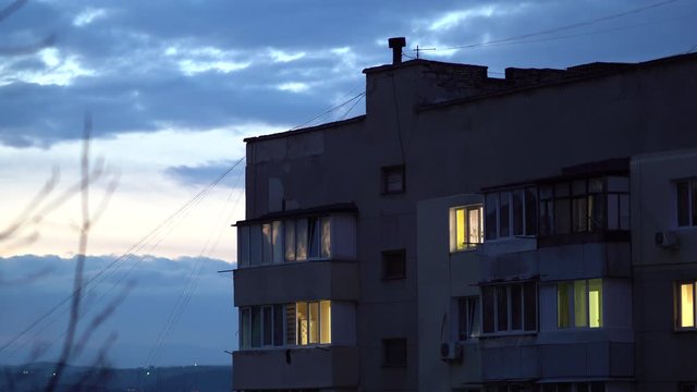 City twilight scene, windows of residential apartment building at dusk in Simferopol.