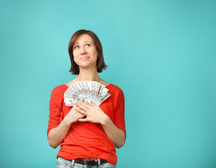 Beautiful  woman with dollars  on blue background