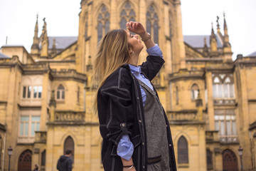Fototapeta premium lifestyle, caucasian blonde enjoying the city with a church in the background