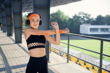 Young woman stretching her legs outdoors in modern environment.