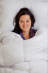 brunette woman just woke up and smiles