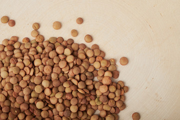 Green lentils on a white background top view. Raw lentils laid out in the shape of a circle.