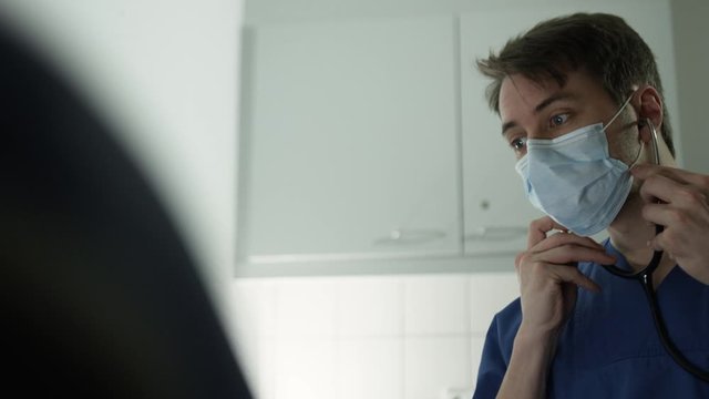 Young Doctor examinates patient in hospital 