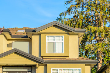 The top of the house or apartment building with nice window.