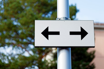 road sign with arrows in two different directions
