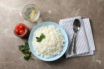 Composition with delicious rice on grey background, top view
