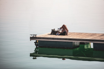 Girl with her dog on the pier