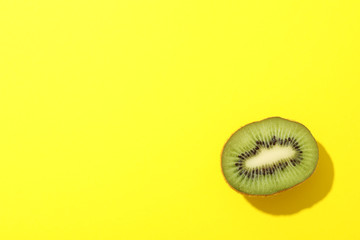 Ripe sweet kiwi on yellow background, top view