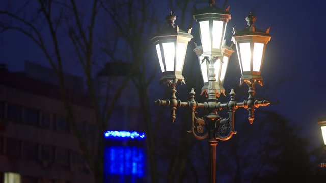 Yekaterininsky Garden in Simferopol lit by lanterns at night, evening city streets. Simferopol, Crimea, Russia.