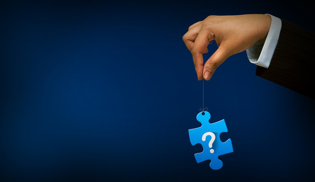 hand holding question mark with puzzle sign - Powered by Adobe