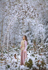girl walks in a winter forest
