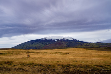 Fototapeta na wymiar Snow mountain range under the ominous clouds -- Iceland 