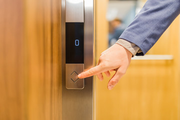 Man forefinger pressing up or down elevator button. Business success or failure concept.