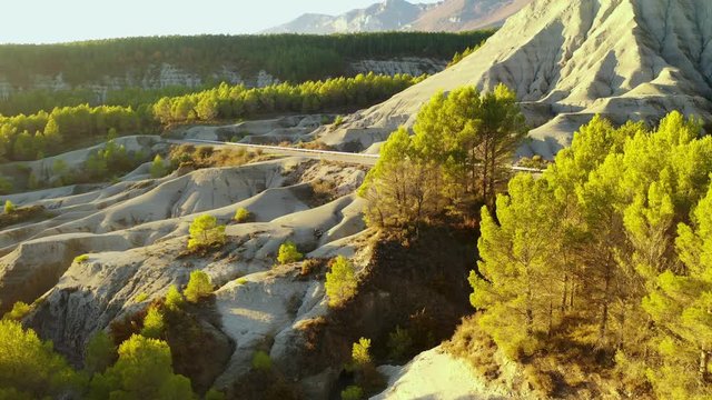 Road in badlands. Yesa reservoir. Saragossa, Aragon, Spain. Europe. Aerial view. 4K.