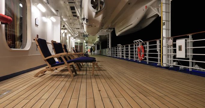Cruise ship night outdoors deck chairs adult friends. Luxury all inclusive vacation travel in style. Passengers enjoy international destinations aboard large ocean vessels. Recreation, shows, fun.
