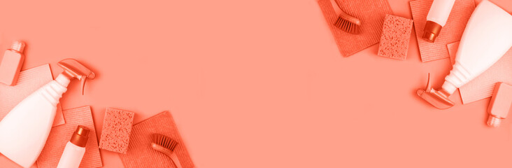 Banner made from house cleaning products are on coral background. Cleaning concept.
