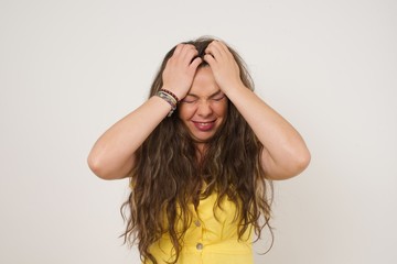 Exasperate female keeps hands on temples, feels strong headache, closes eyes with pain, need...