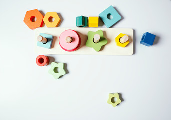 Wooden toys at home. Color educational toy on a gray background. Child development. Сhildren background. Lifestyle.