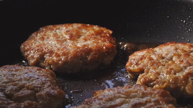 Cooking hamburger. Beef or pork cutlet grilling on pan.