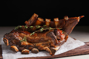 Delicious roasted ribs served on table, closeup